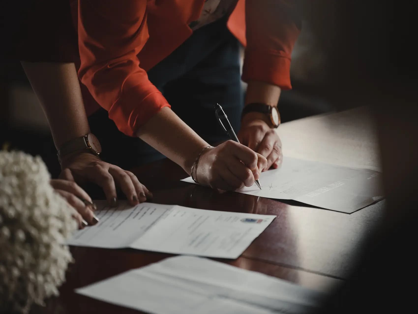 Woman Signing Documents